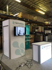 RENTAL: RE-1061 Gravitee Panel System Inline Design with Storage Closet with Locking Door, Large Monitor Mount, 43&rdquo; Monitor, RE-1567 Backlit Reception Counter, SEG Fabric Graphics -- View 2