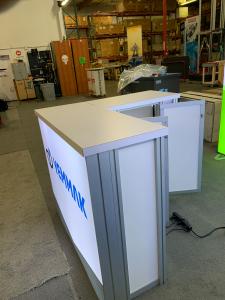 RENTAL: (2) RE-1043 Single-Sided Lightboxes Attached in L-Shape Configuration, RE-1572 L-Shaped Backlit Reception Counter, SEG Backlit Fabric Graphics -- View 4
