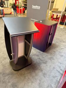 Custom Exhibit with LED Halo and Backlit Lights, SuperNova Header Lightbox, Lighting Remote, SYM-416 Counter with Fabric Graphics, and MOD-1549 Lectern with Graphics -- View 4