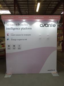 Custom Inline Exhibit with SEG Fabric Backwall, Laminated Header, Puck Lights, Monitor Mount, and Modifited MOD-1596 Counter with RGB Halo Light Logo and Locking Storage -- View 3