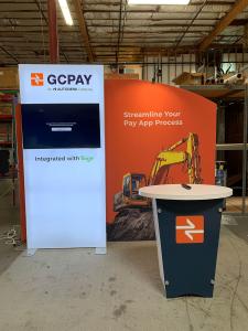 RENTAL: Modified RE-1090 Design with Arch Extrusion Frame, Single-Sided Lightbox at 42" Wide x 95" High, Large Monitor Mount, 43" Monitor, LED Arm Light, RE-1201 Reception Counter with White Laminate Finish, SEG Graphics, and Front Vinyl Applied Counter G