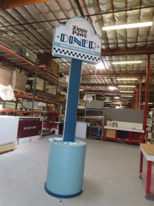 Custom Counter with RGBW LED Lights, Rounded Corners, Push-thru Backlit Logo, and Locking Storage and Freestanding Sign with LED Accent Lights -- View 3